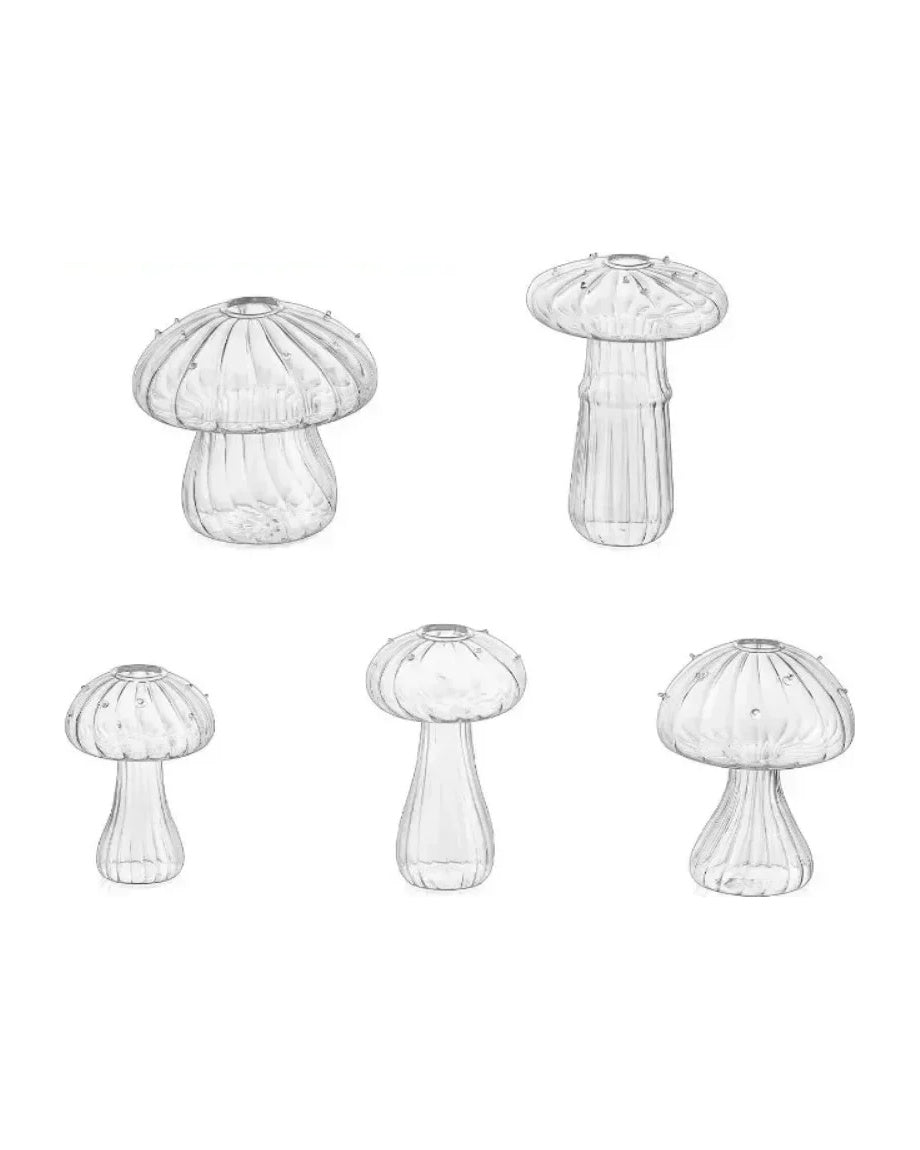 Five clear fluted glass mushroom vases, each a different shape, on white