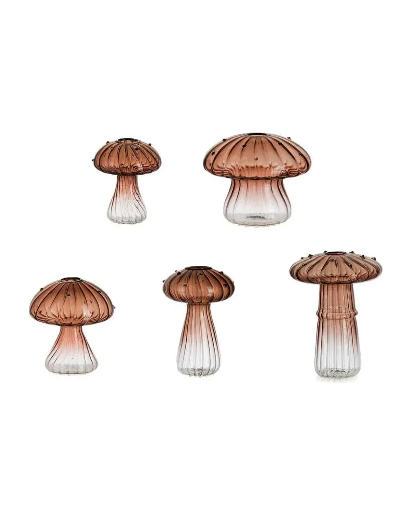 Five fluted glass mushroom vases in a coffee to clear gradient, on white