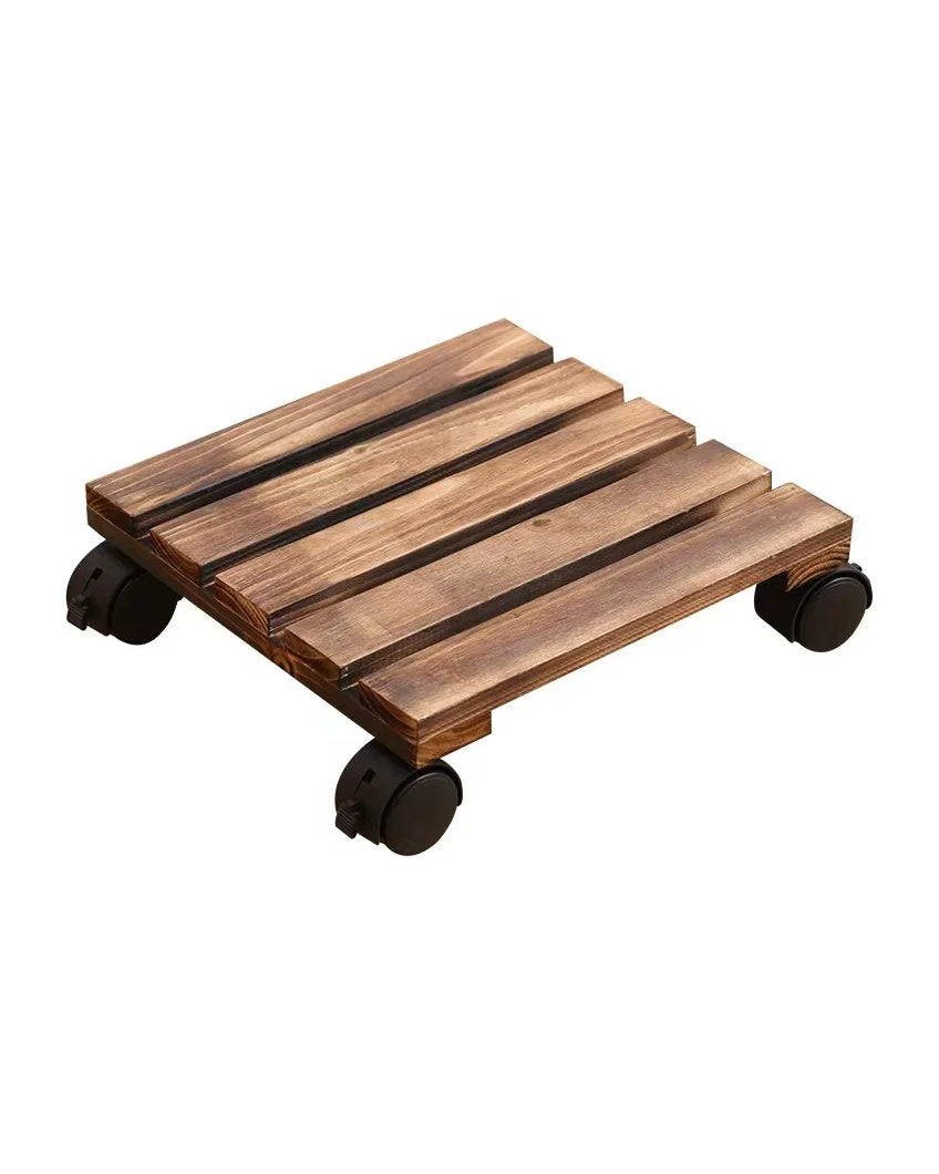 Square rolling plant caddy in solid wood on four black casters, on white